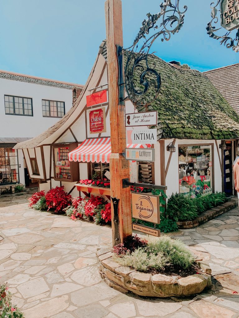 white and brown fairytale cottage with cobblestone