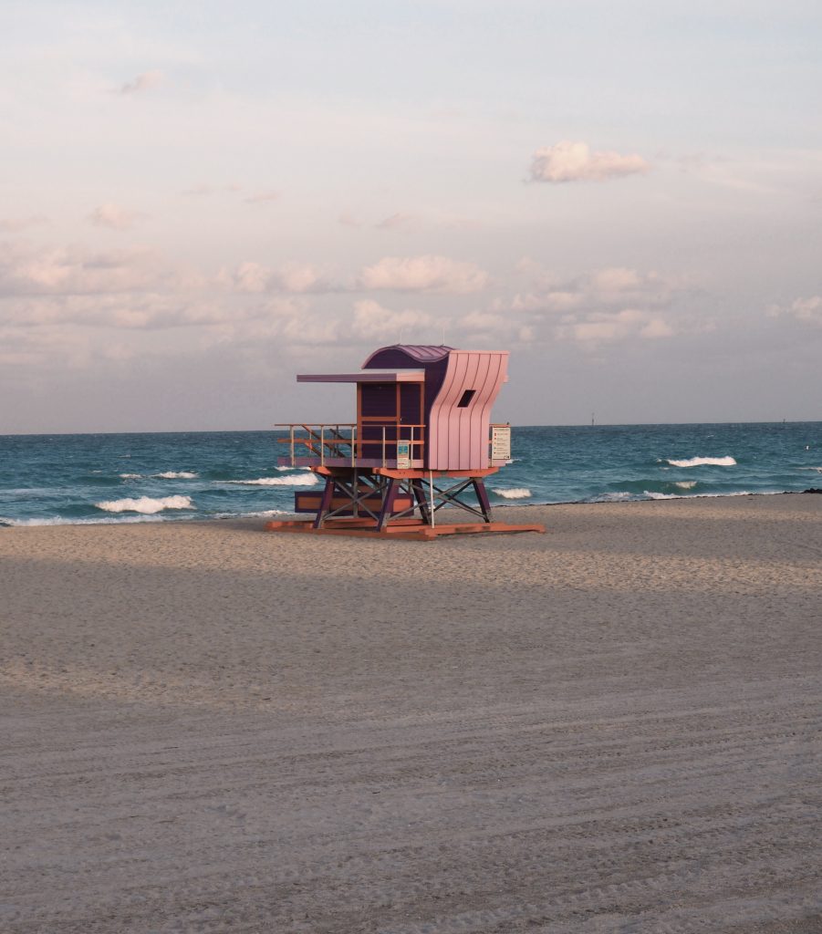 Pastel pink life guard shack on beach in Miami. Perfect stop on a Florida roadtrip with family