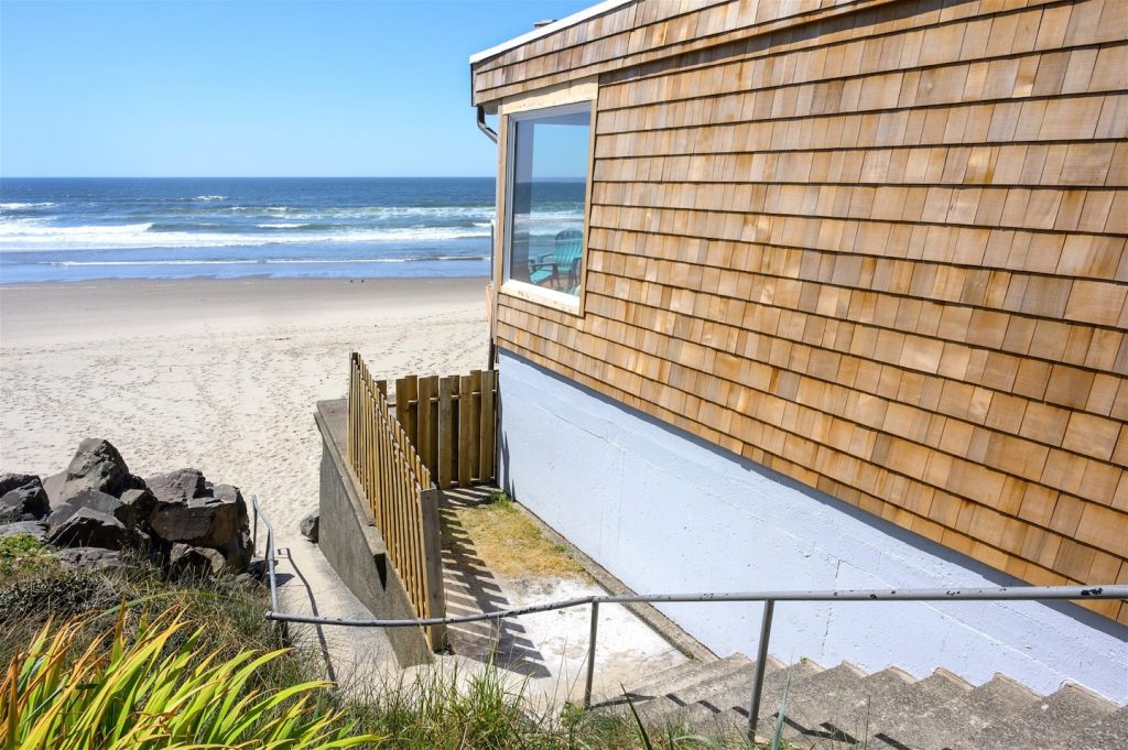 This Airbnb on the Oregon coast is a brown cottage sitting right on the beach