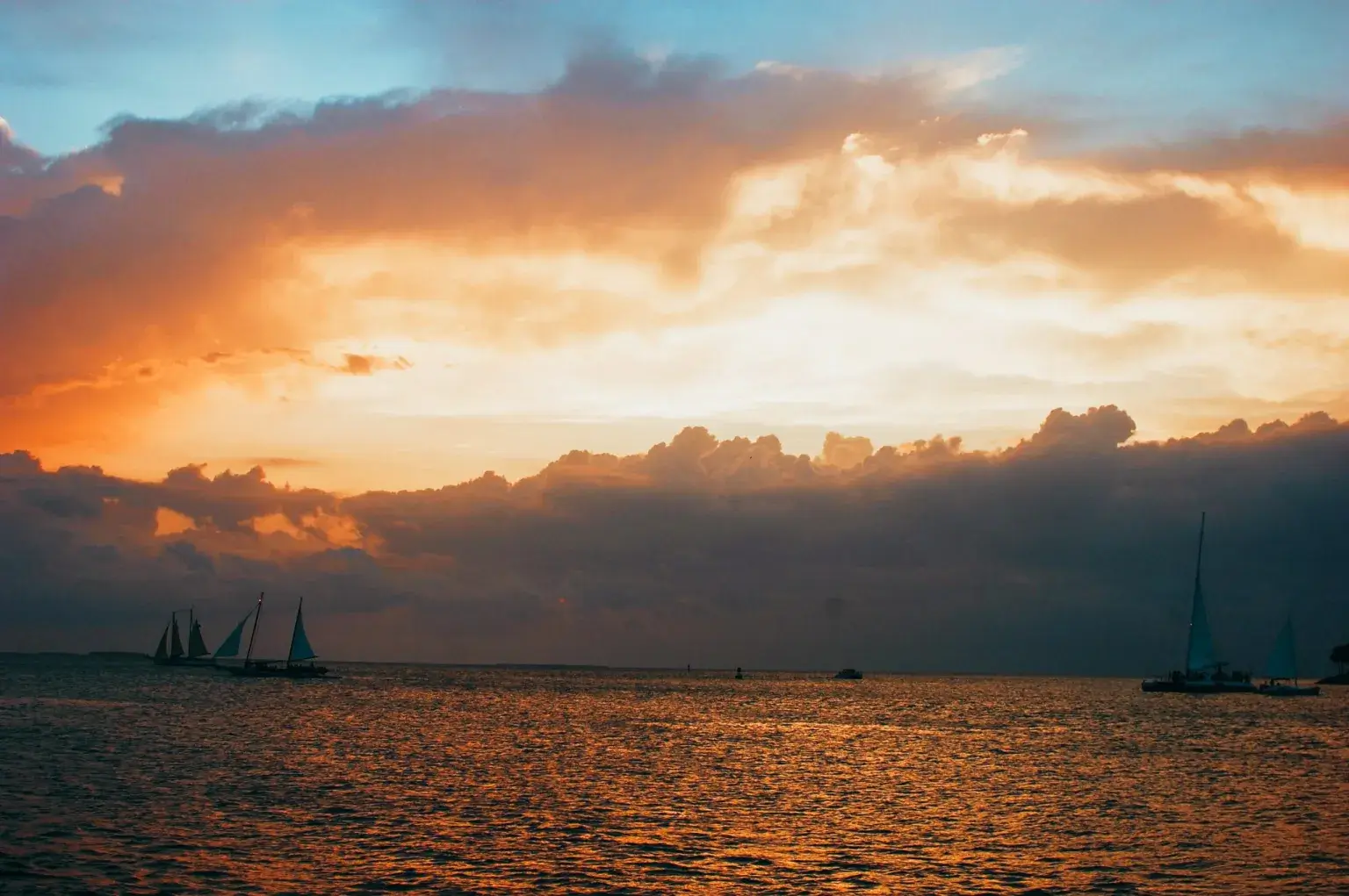Orange and yellow sunset with clouds in Key West ,Florida during a sunset sail.