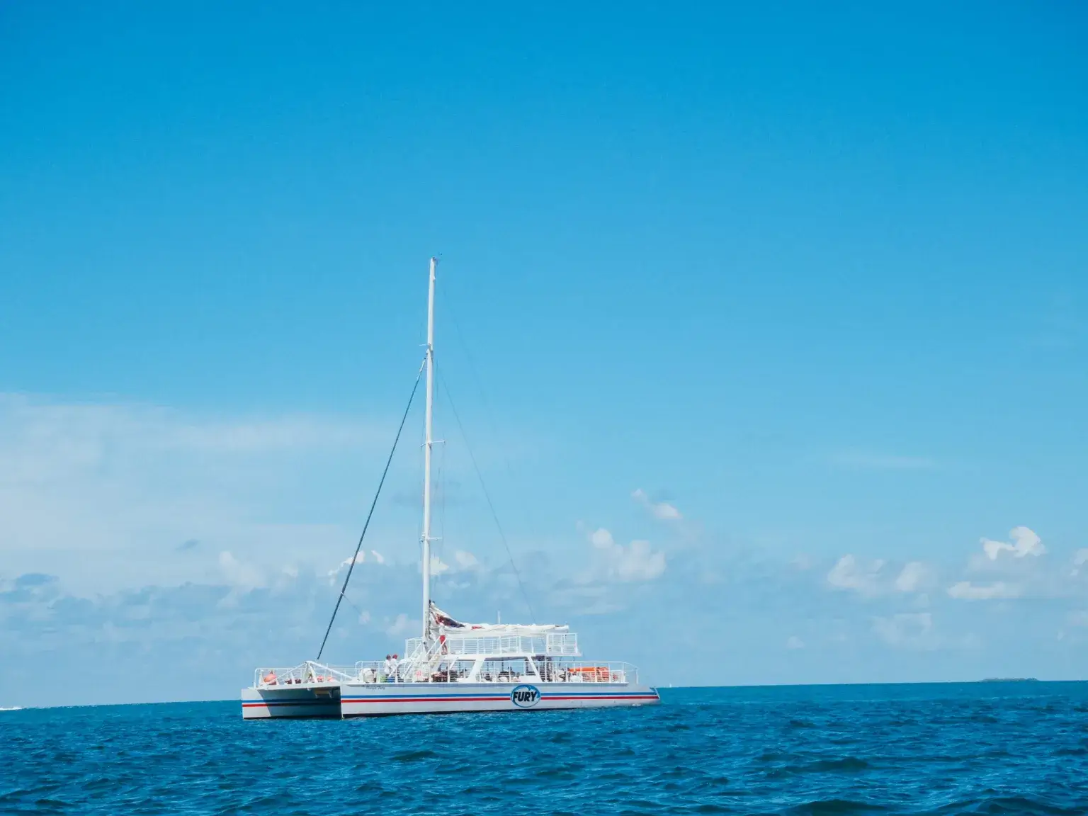Large white catamaran on the open ocean