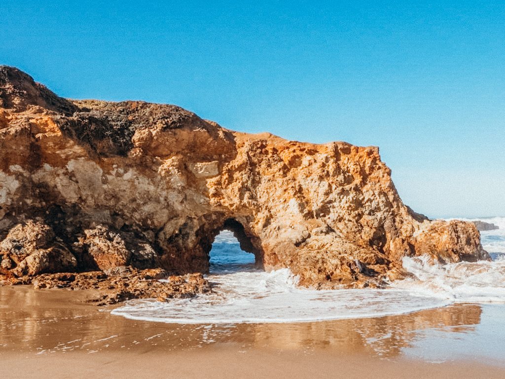 Large rock formation on beach at Pescadero California State Beach