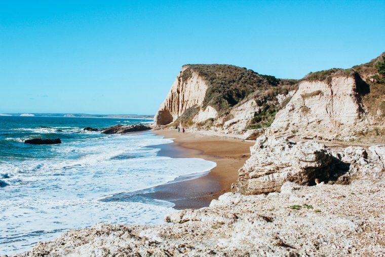 Ocean waves on shore with rocky cliffs at Point Reyes California State Reserve