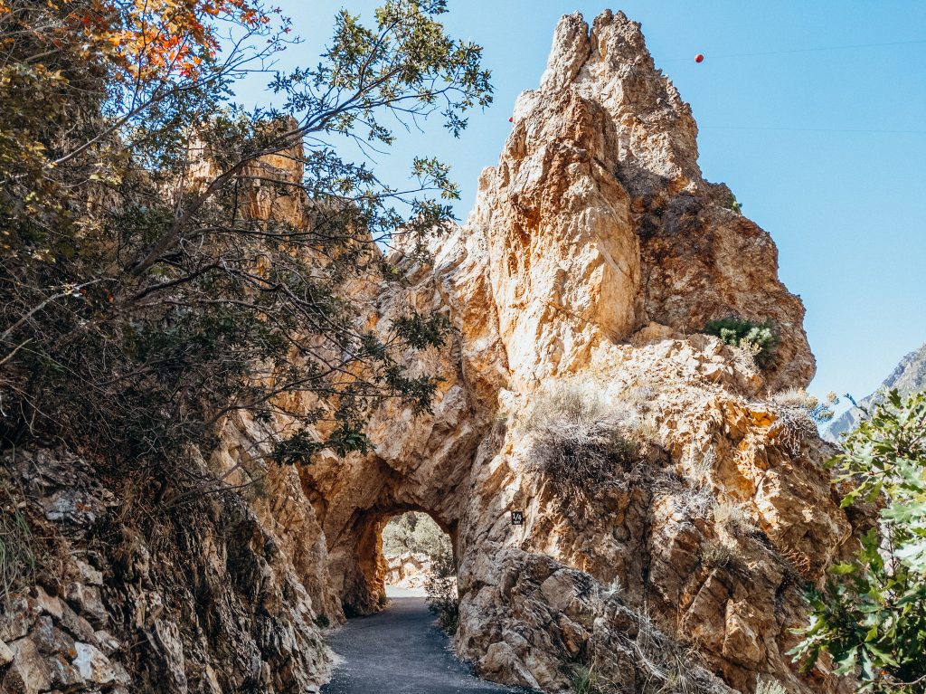 Rock arch over paved trail