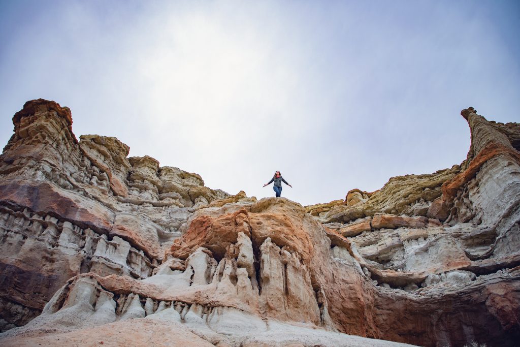 Woman on large red and white rock pillars at Red Rock Canyon California State park
