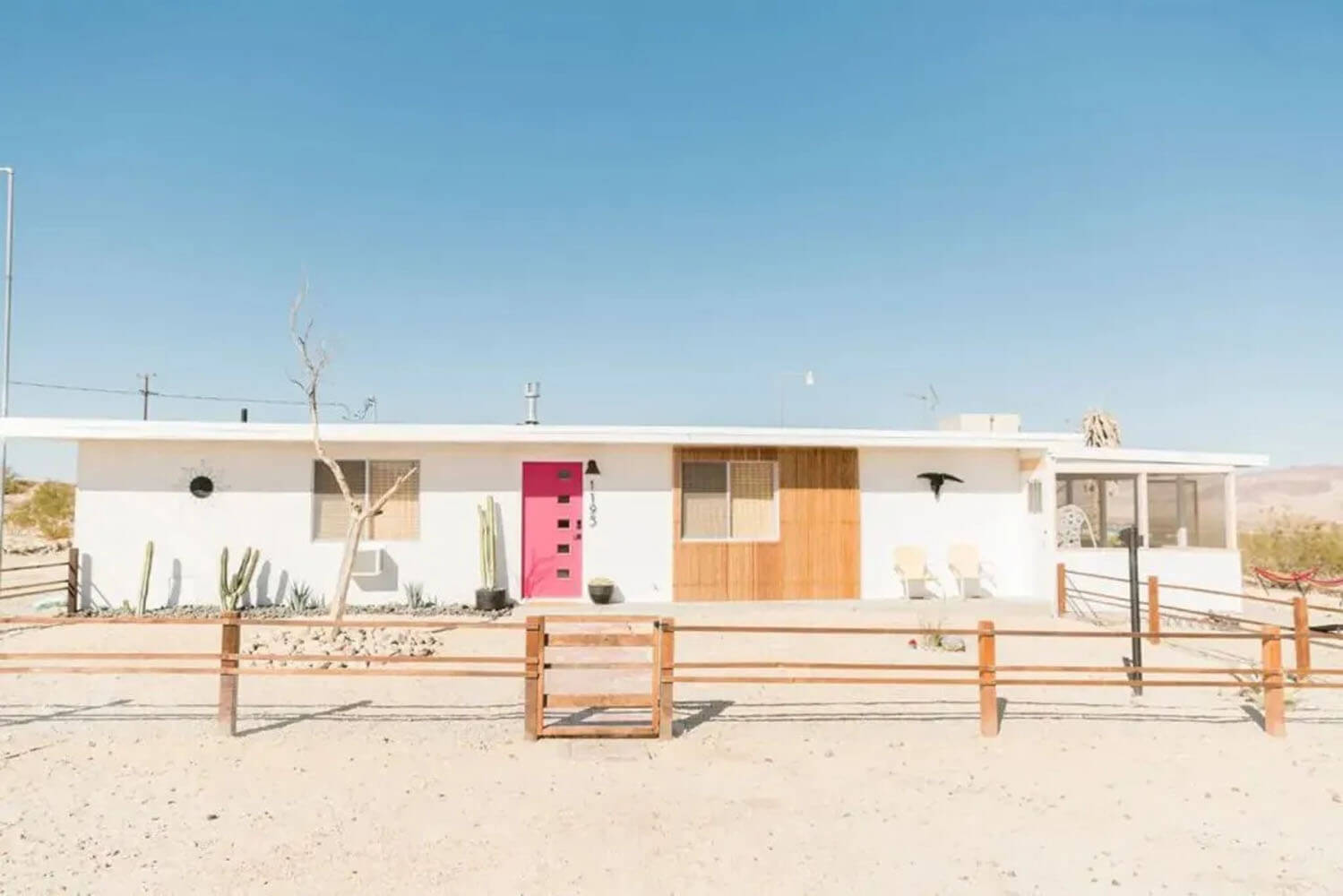 Unique Airbnb in Joshua Tree, California with white paint and pink door