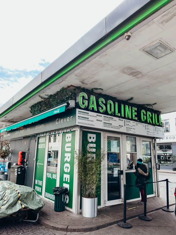 Green and white walk-up hamburger stand with a neon green sign that reads ' Gasoline Grill'