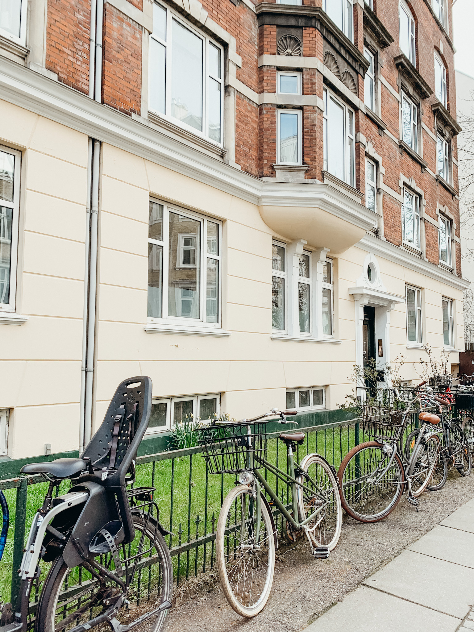 Bikes lining rail along old building in Copenhagen