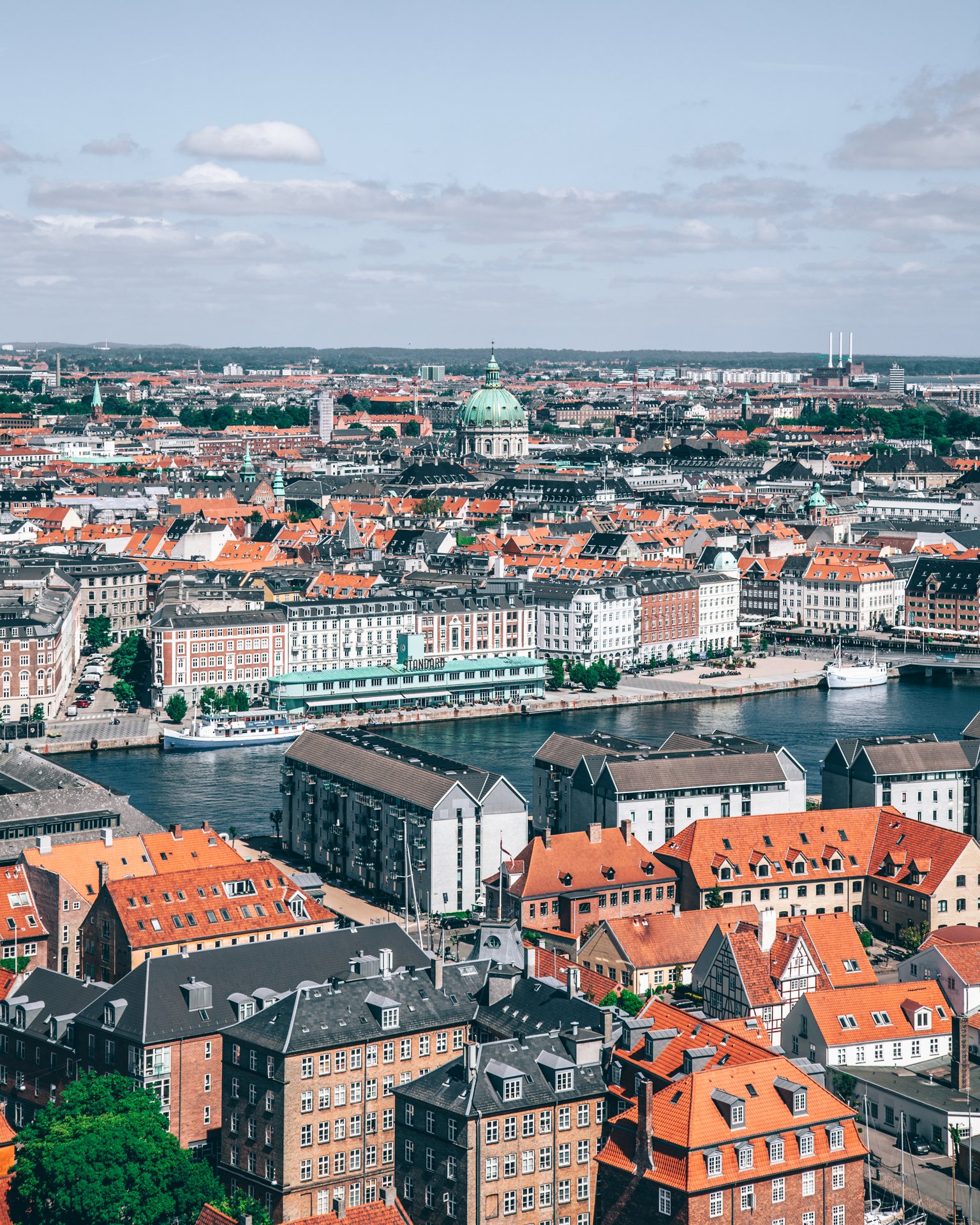 Ariel views of old buildings with orange roofs around a harbor in Copenhagen Denmark