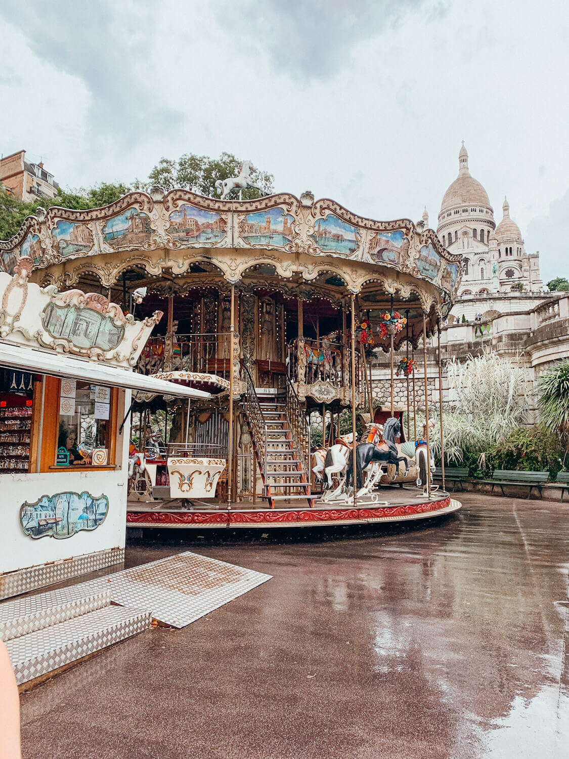 carousel in front of ornate white building in montmartre paris