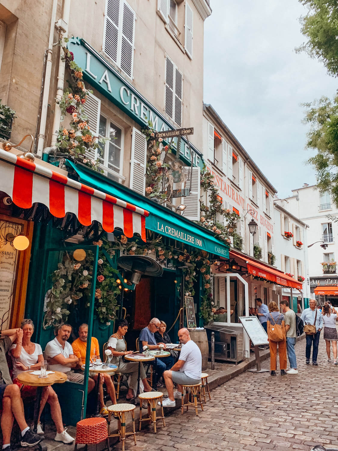 Colorful cafe fronts on cobblestone street in Place du Tertre Paris