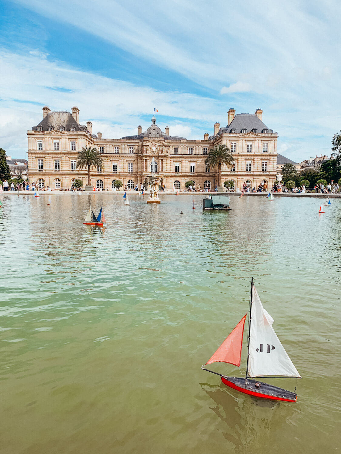 Toy sailboat on pond in front of the palace at Luxembourg Gardens