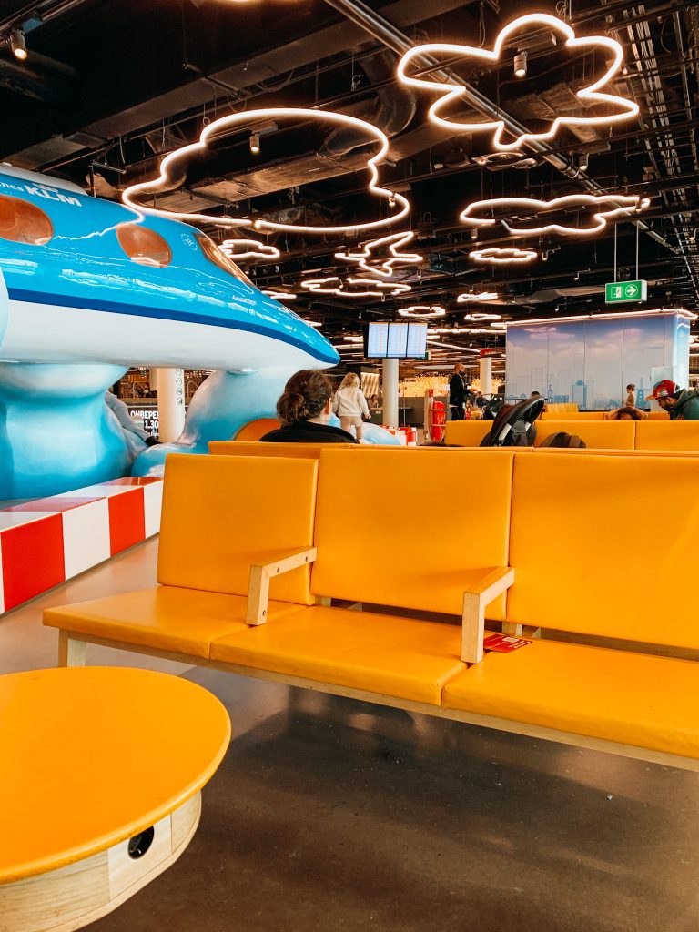 Yellow chairs next to playground in the airport