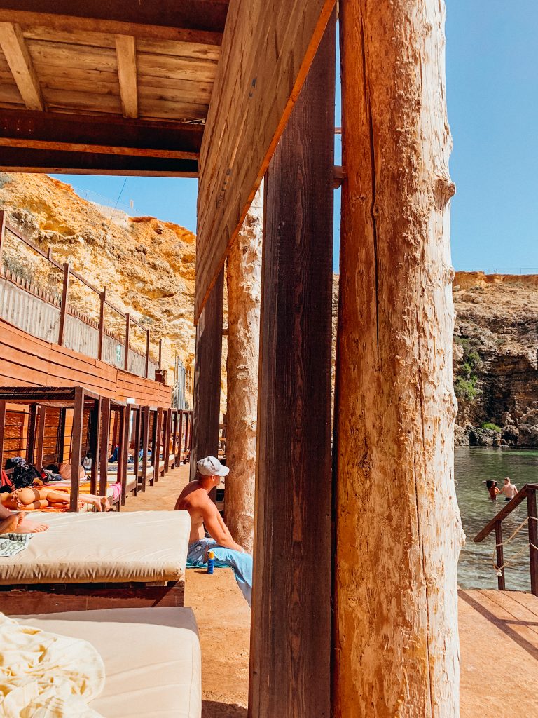 Sun beds line cove in Malta and Popeye Village