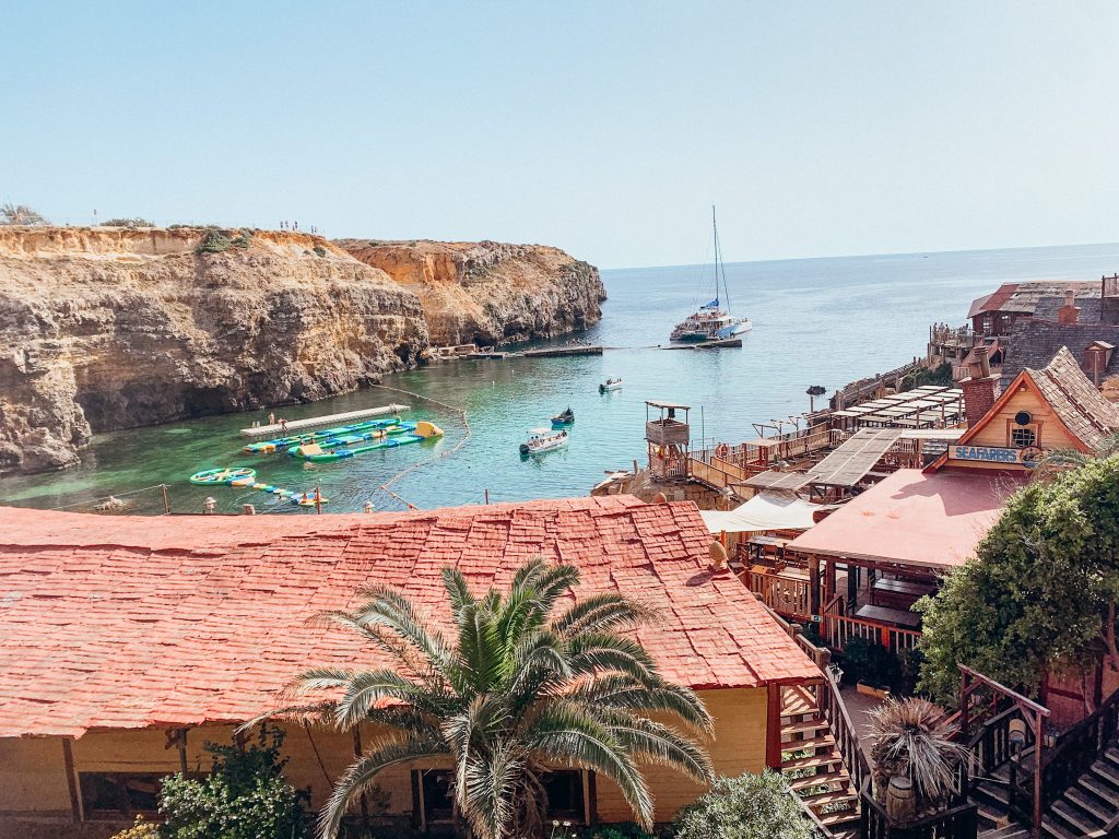 Arial view of Popeye Village including wooden buildings and cove with green water