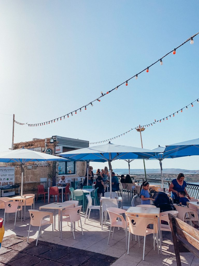Chairs and blue umbrellas at a cafe in Malta