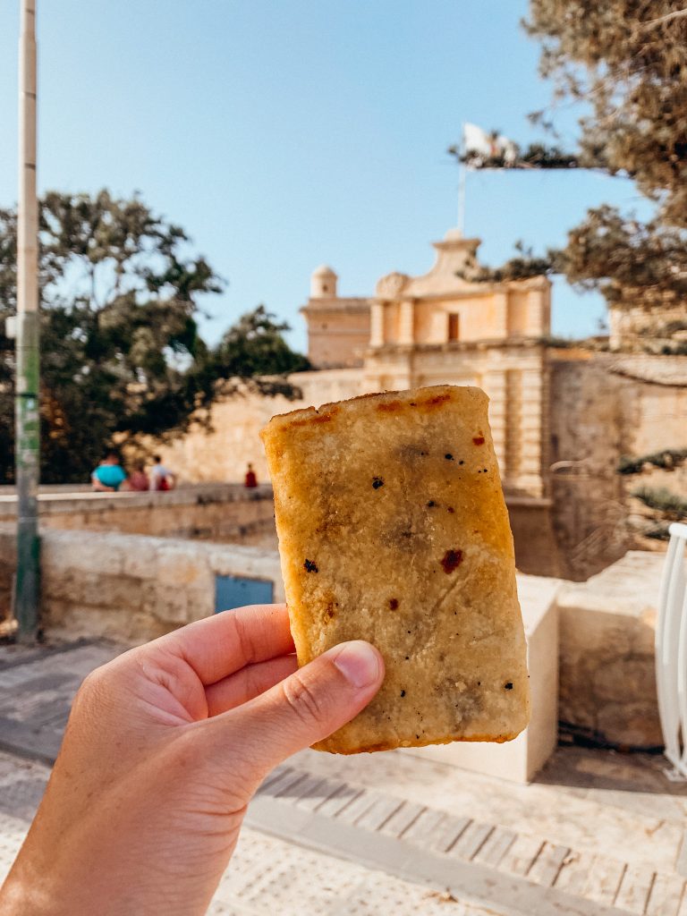 Hand holds a rectangle fried pastry