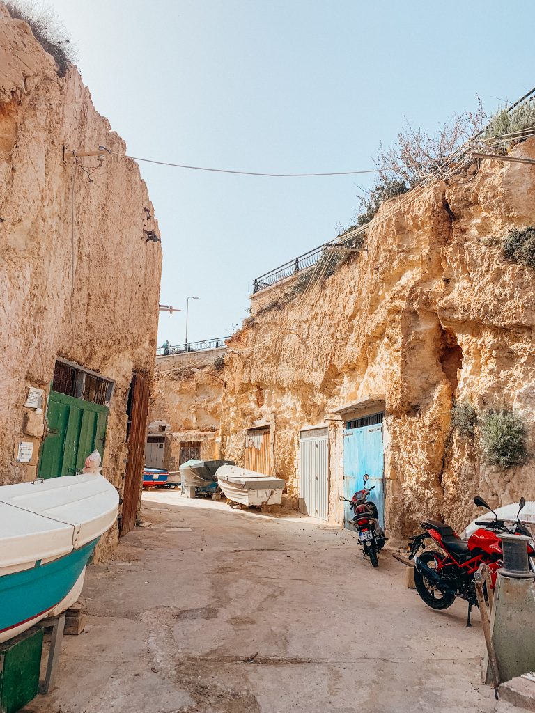 Colorful, wooden doors built into an orange rock cliff
