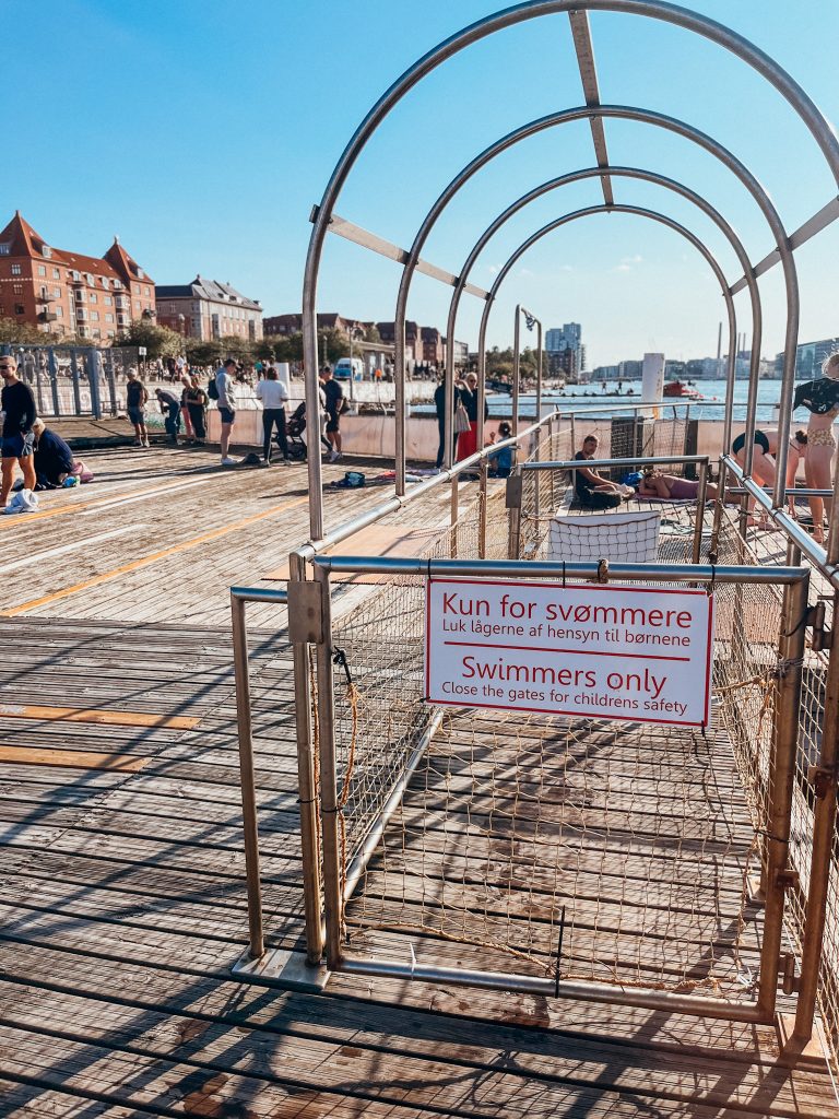 Metal fence at an outdoor pool to keep children out of the deep area