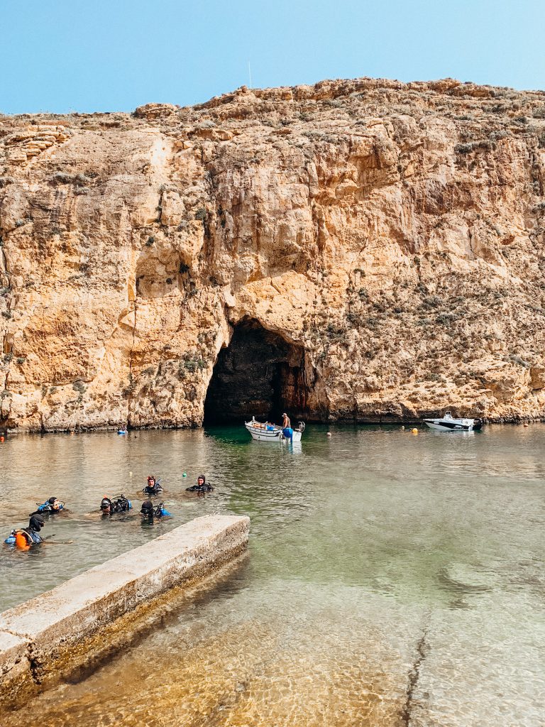 Boat driving through rock tunnel