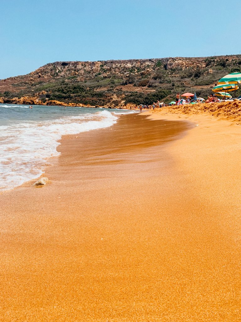 Red sand with blue water and waves