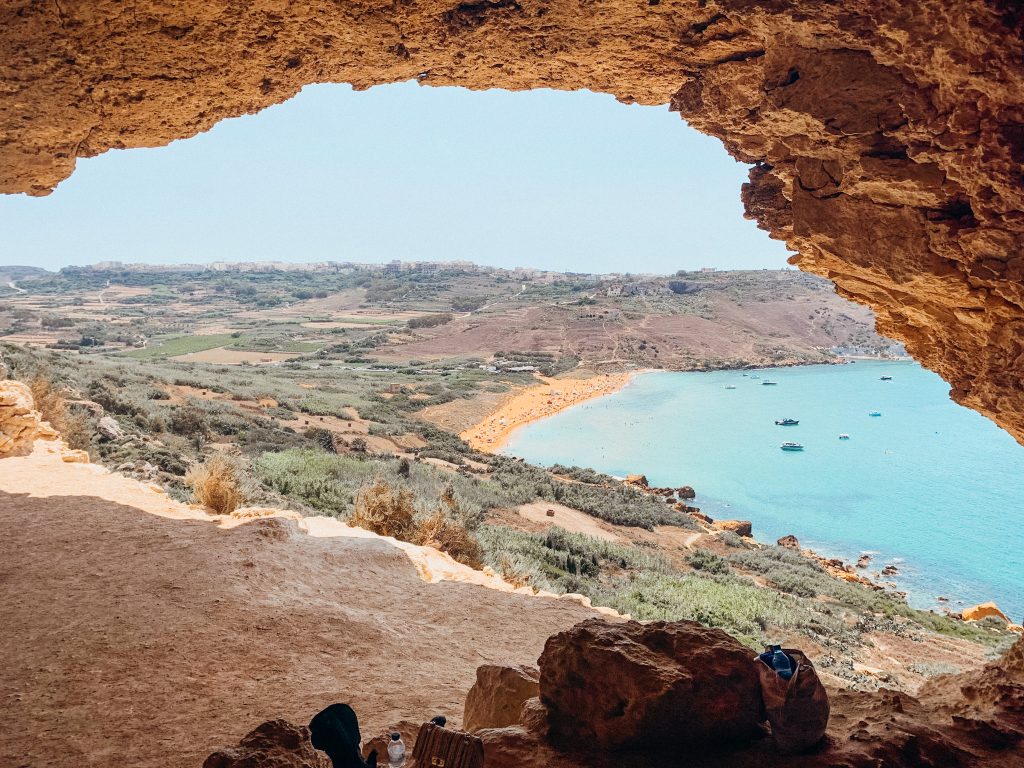 Cave opening overlooking the countryside, beach and sea