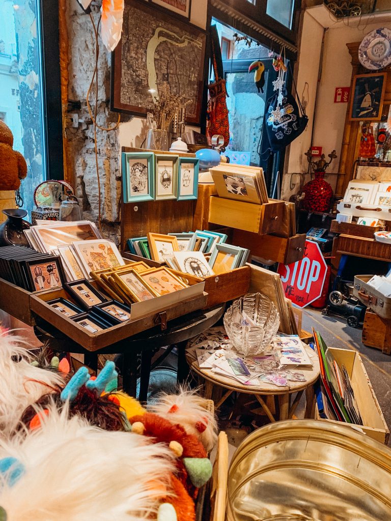 Framed drawings fill drawers in a small shop selling trinkets