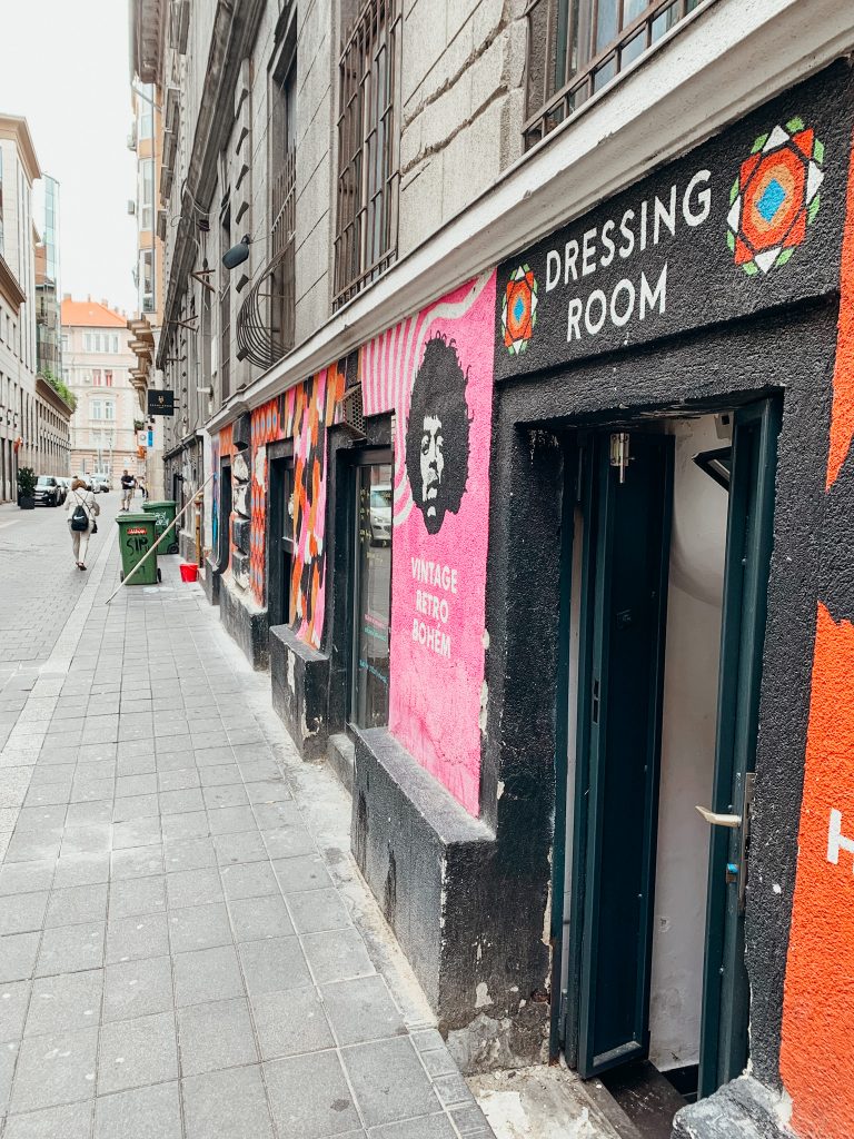 Storefront along city street painted black and pink with the words 'Dressing Room, Vintage, Retro and Bohem' on the wall