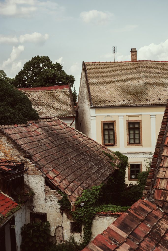 Old houses with worn singles stand next to one another