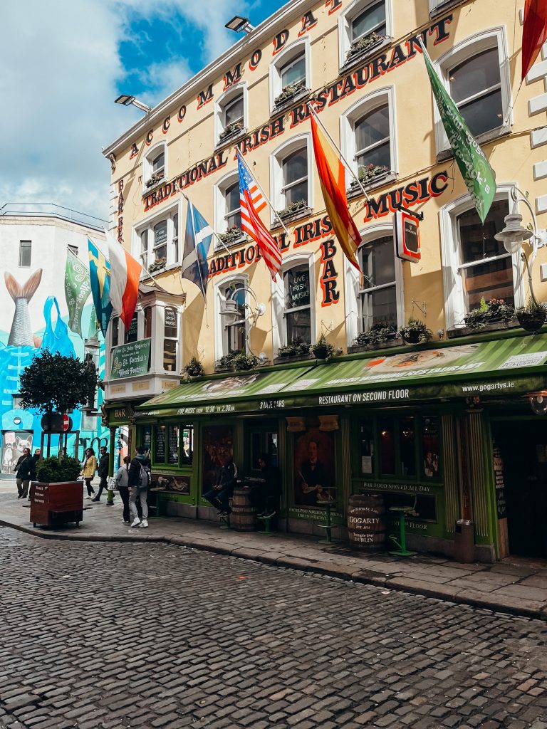 Colorful yellow, green and orange building along a cobblestone street in Dublin Ireland