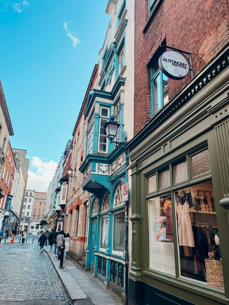 Green and blue buildings along a small pedestrian street in Dublin