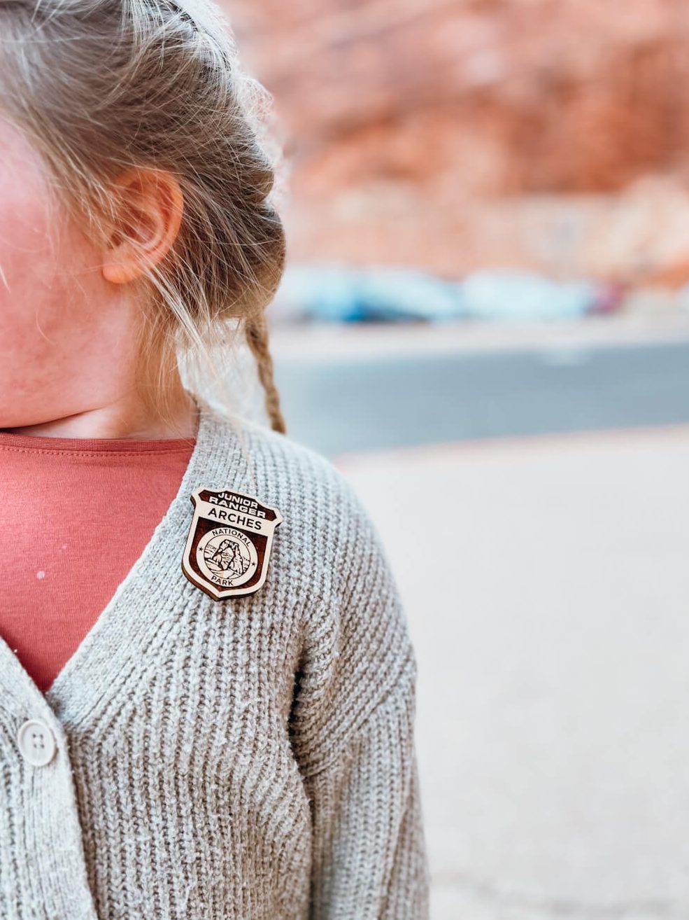 Close up of brown Arches Junior Range Badge on a child's sweater