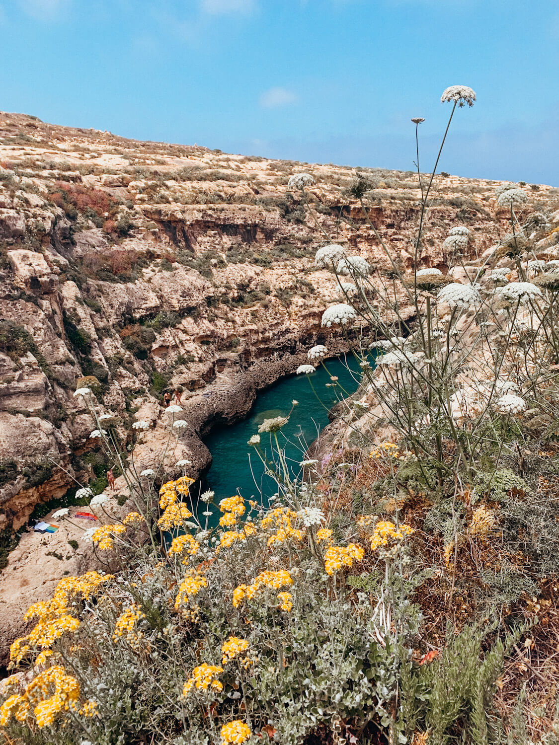 Green water winds it's way past rocky cliffs at Wied Il-Ghasri in Gozo