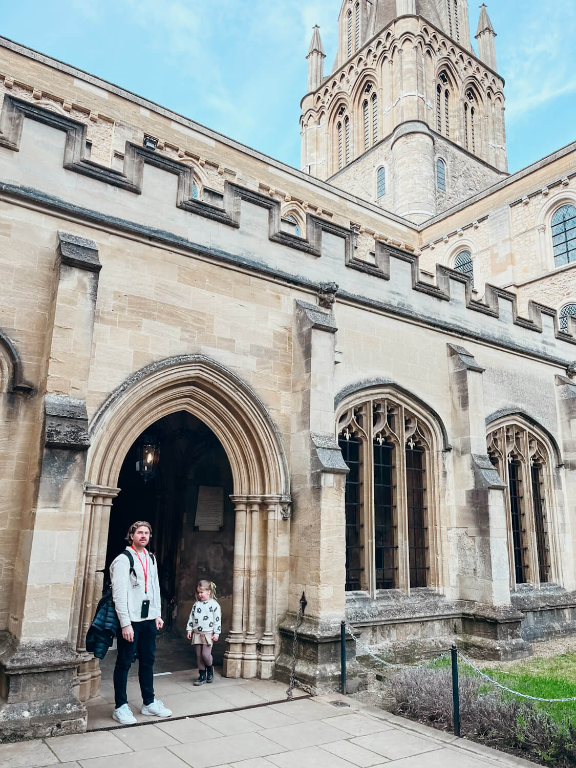 Man and child stand in stone archway at Christ Church College