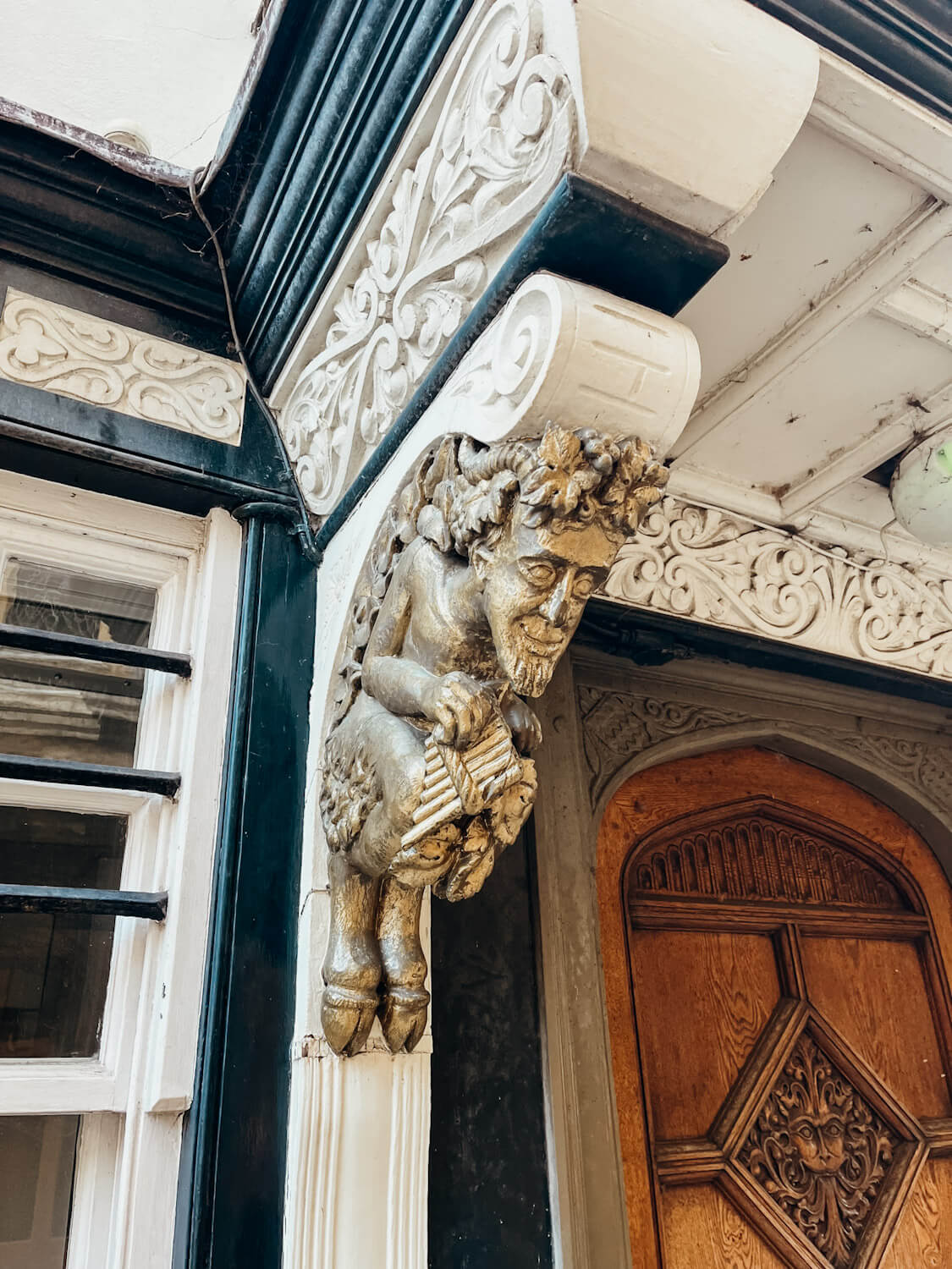 Ornate wooden door with ornate wooden doorframe with gold mystical creatures for decoration