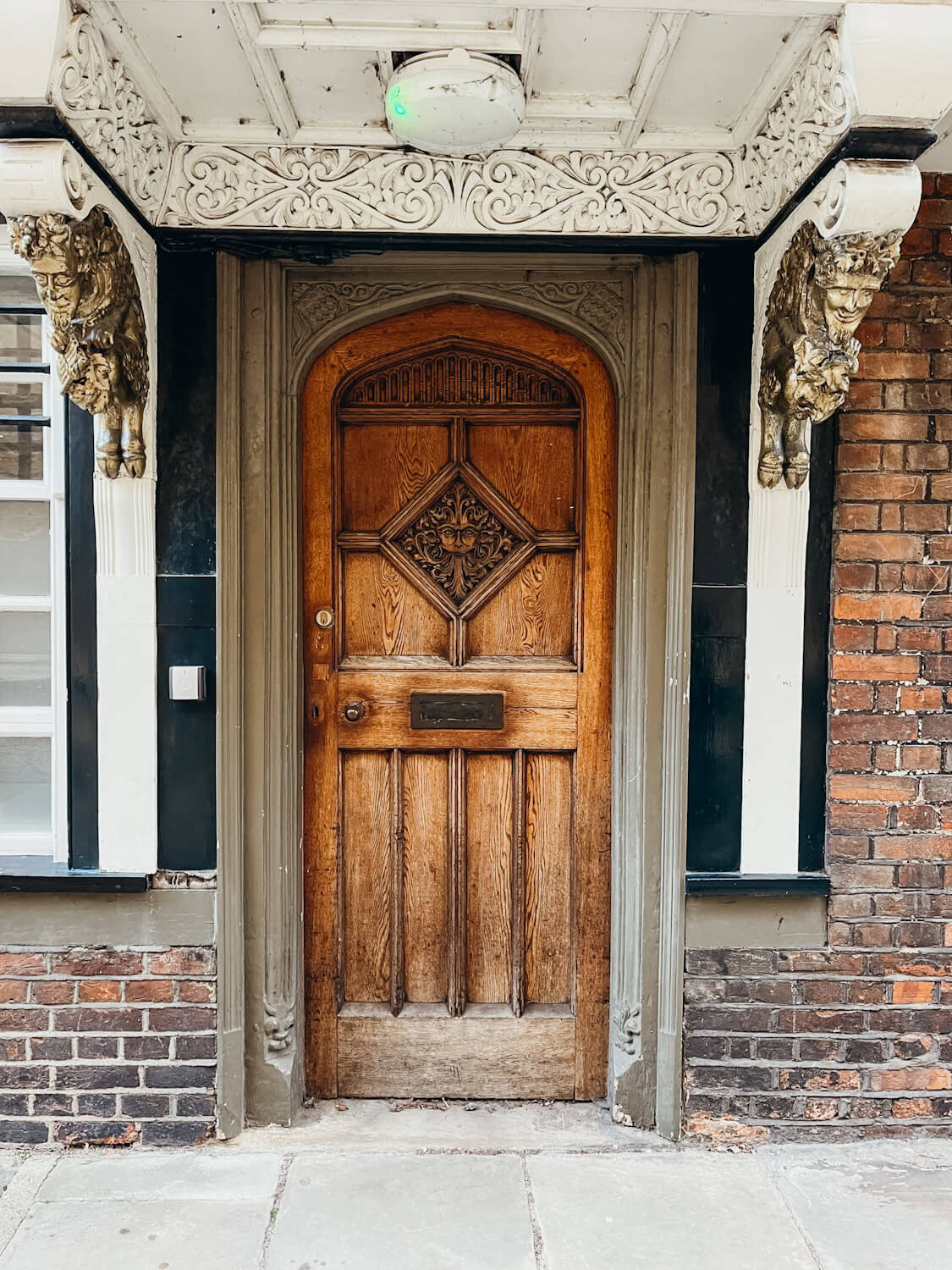 Ornate wooden door with ornate wooden doorframe with gold mystical creatures for decoration