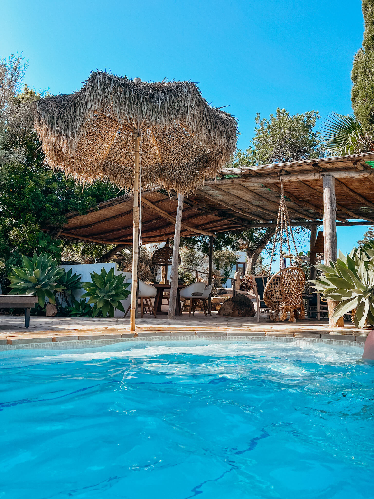 Pool with bohemian outdoor sitting area in Ibiza Spain