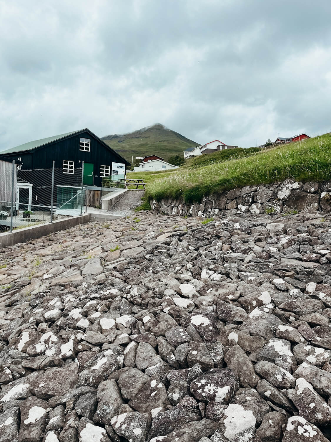 Paved stones next to a black building in the Faroes