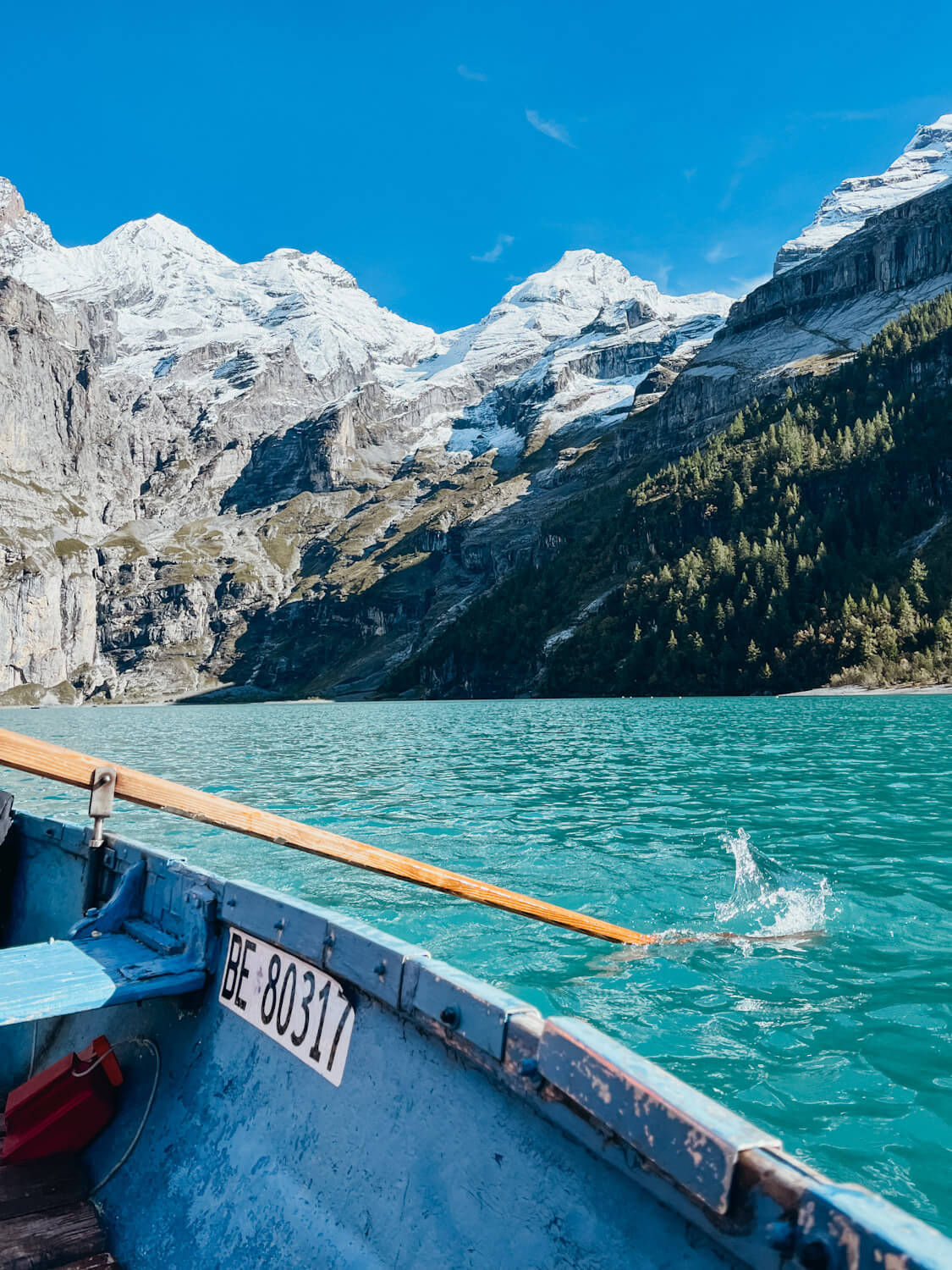 Blue rowboat on blue mountain lake in Switzerland