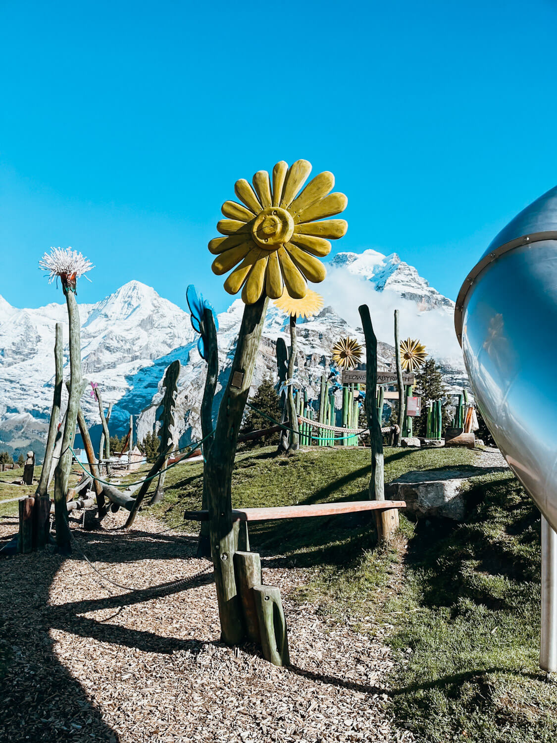 Playground in Switzerland with large wooden flower decorations