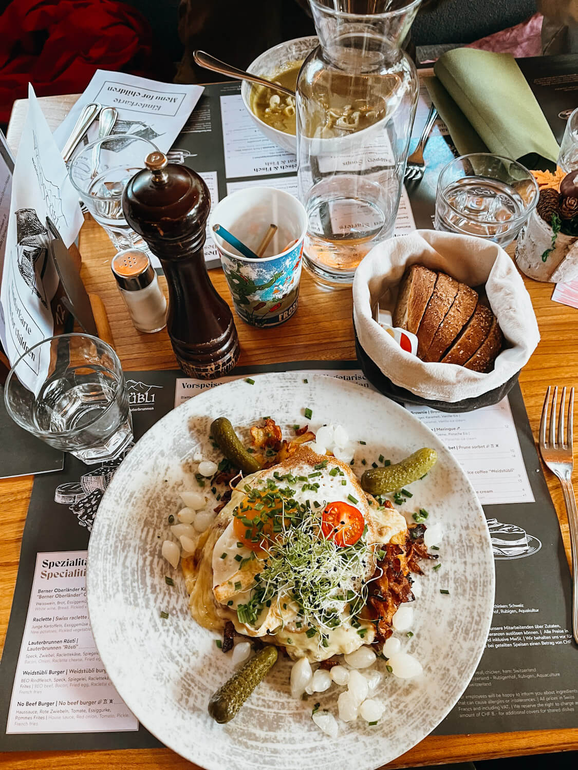 Dinner table at Restaurant Weidstübli with white plates with Swiss Rosti