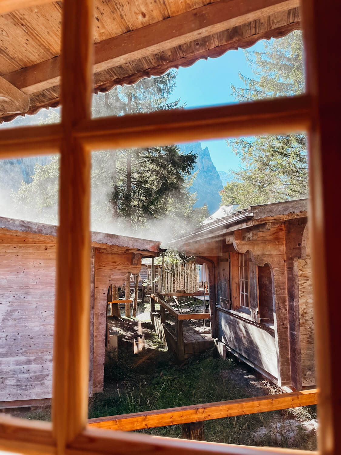 View of small wooden bungalows in Lauterbrunnen Switzerland through a window pane