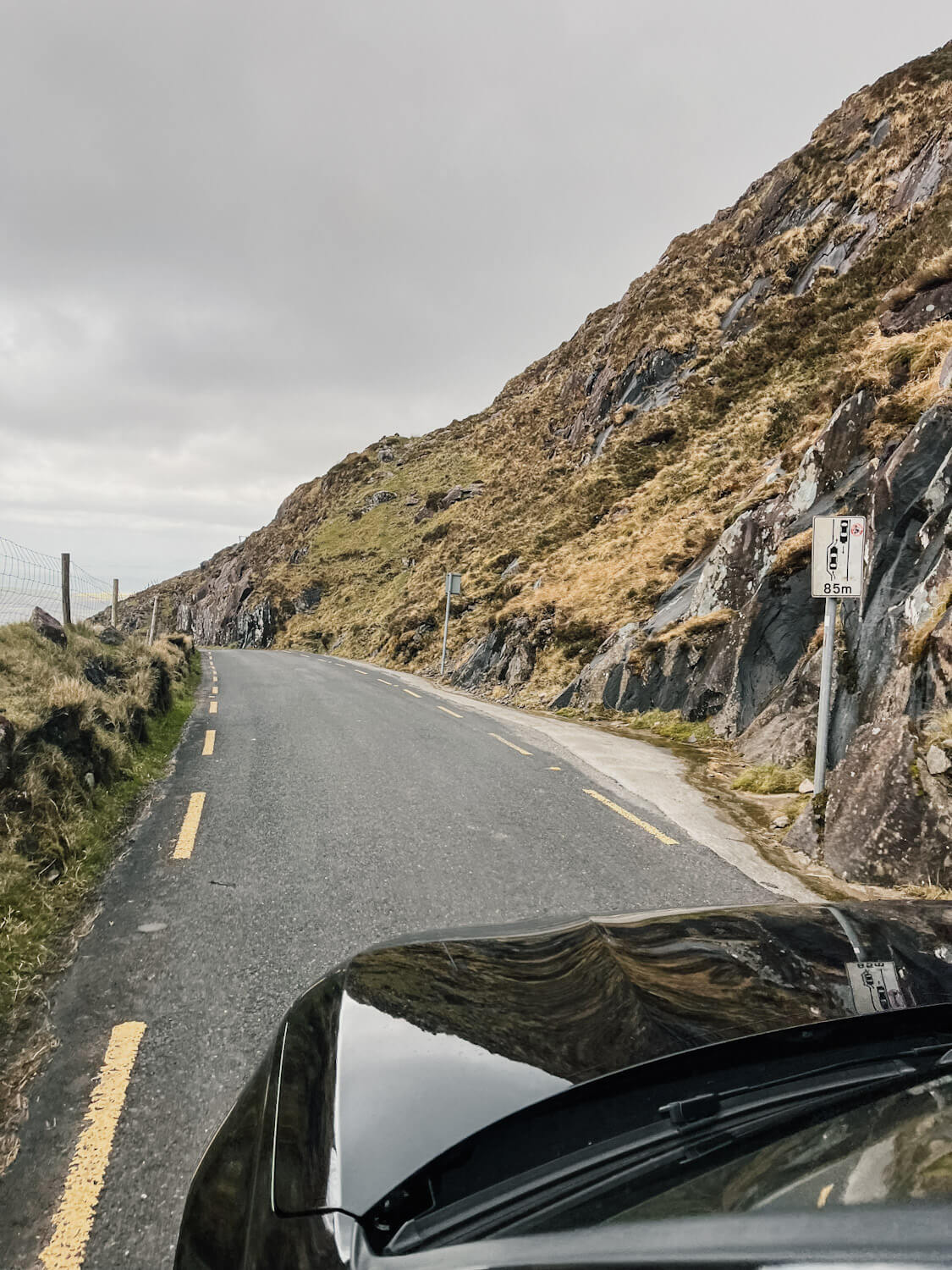 View of front of car driving down narrow road on Conor Pass Dingle