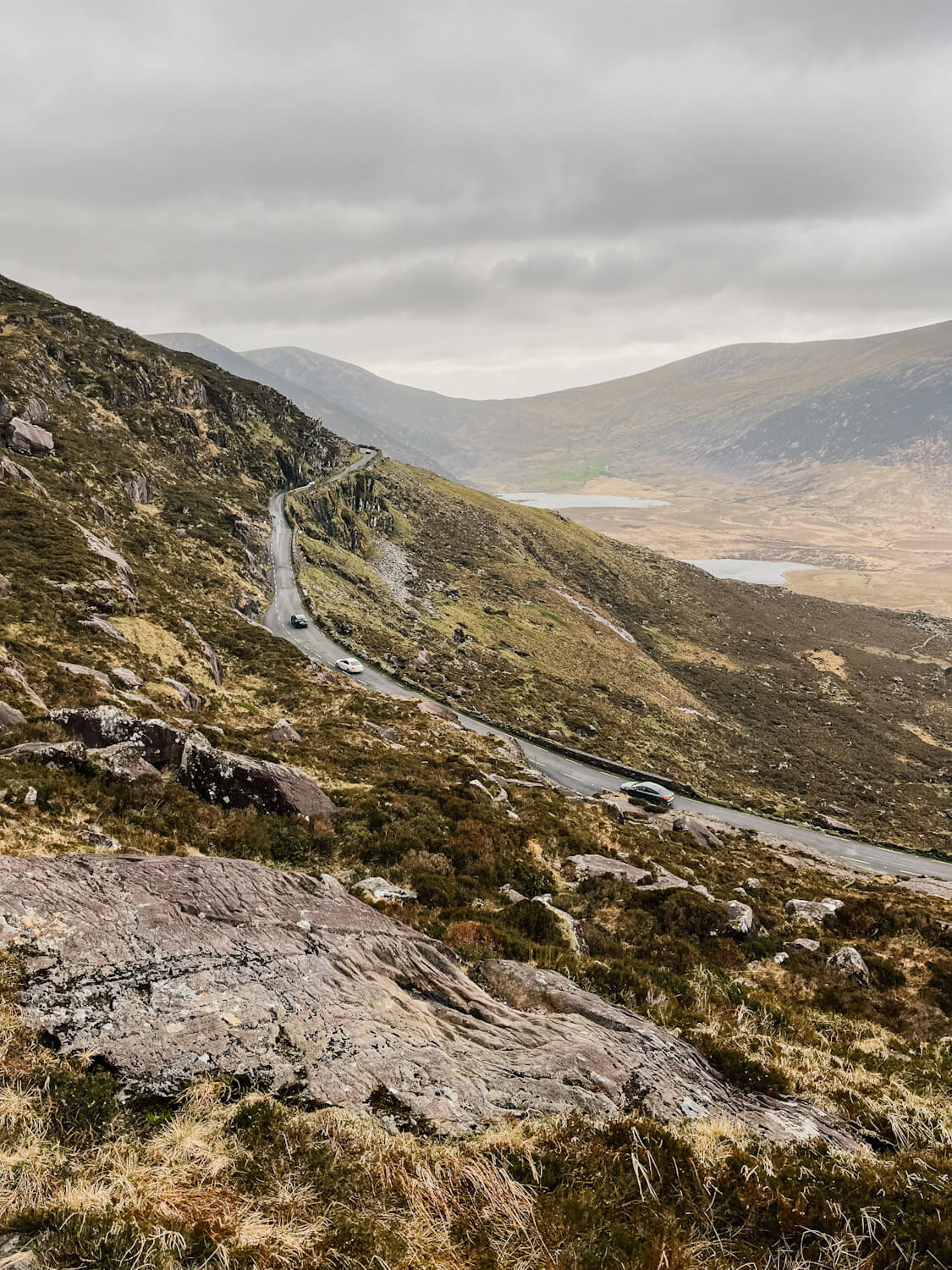 Narrow road cut into the mountainside on Conor Pass on the Dingle Peninsula