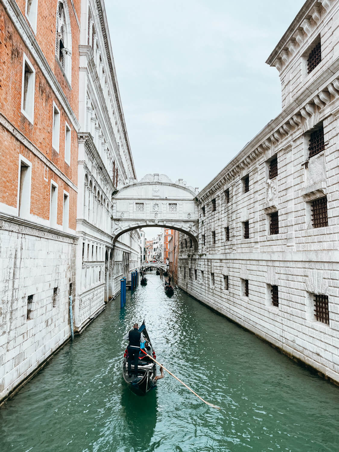 Gondola goes under Bridge of Sighs in Venice Italy in two days