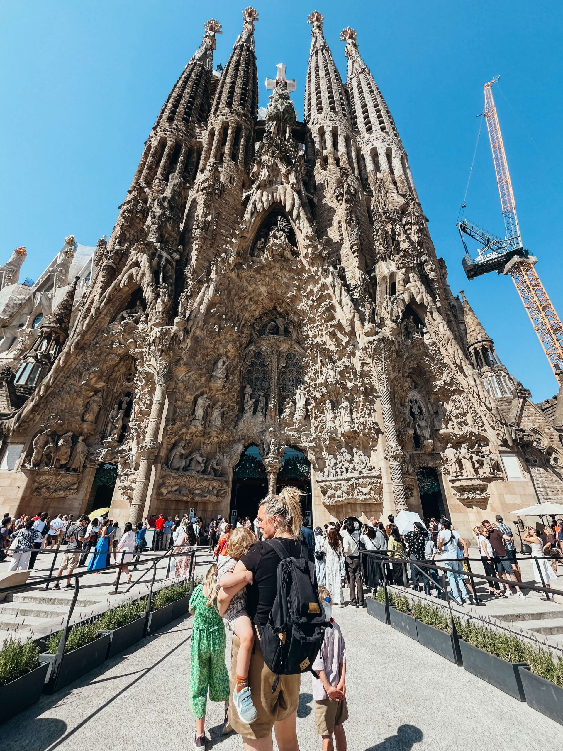Woman and children stand in front of Sagrada Familia in Barcelona in June
