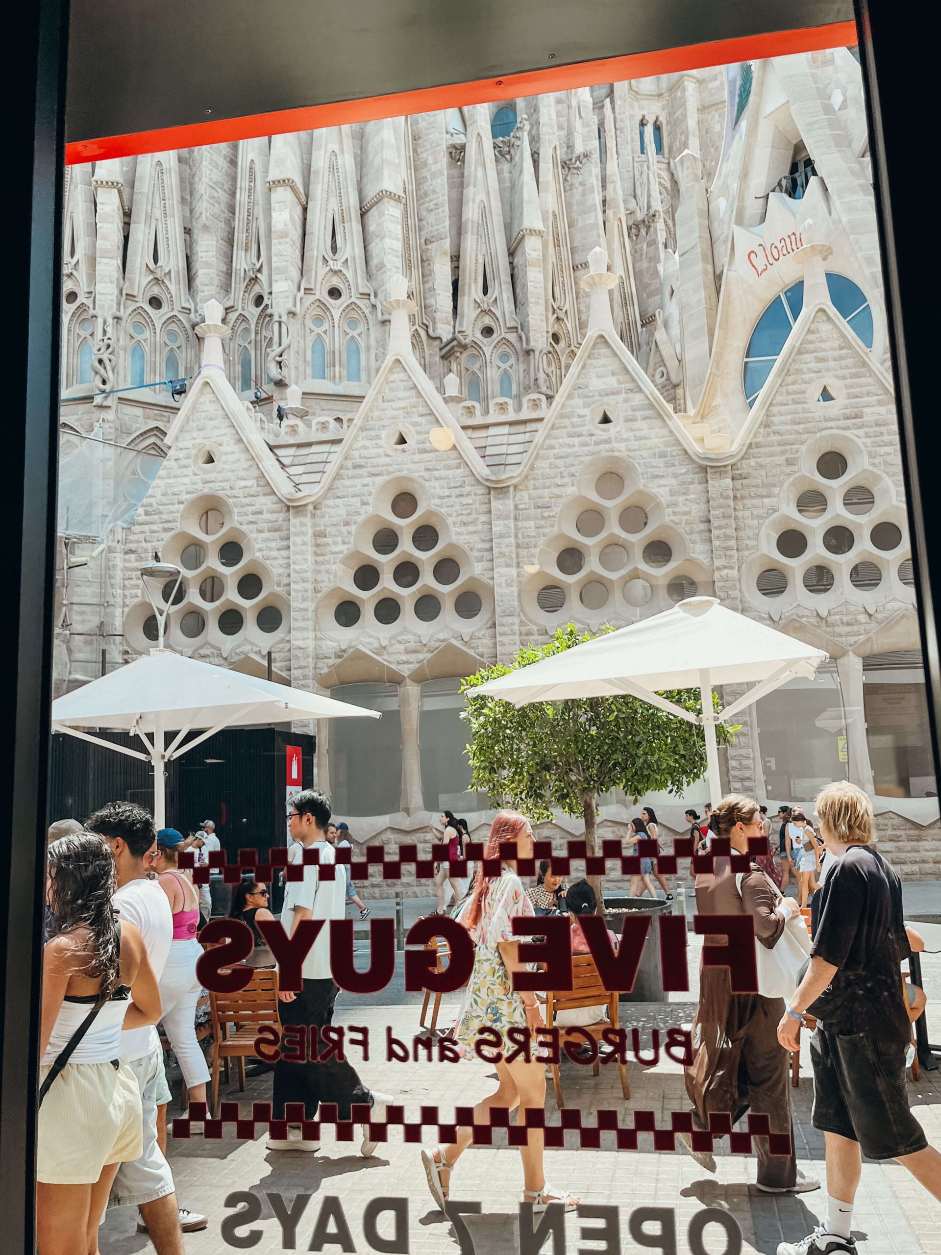 View looking out of Five Guys glass door of views of Sagrada Familia - a great place to eat with kids near Sagrada Familia
