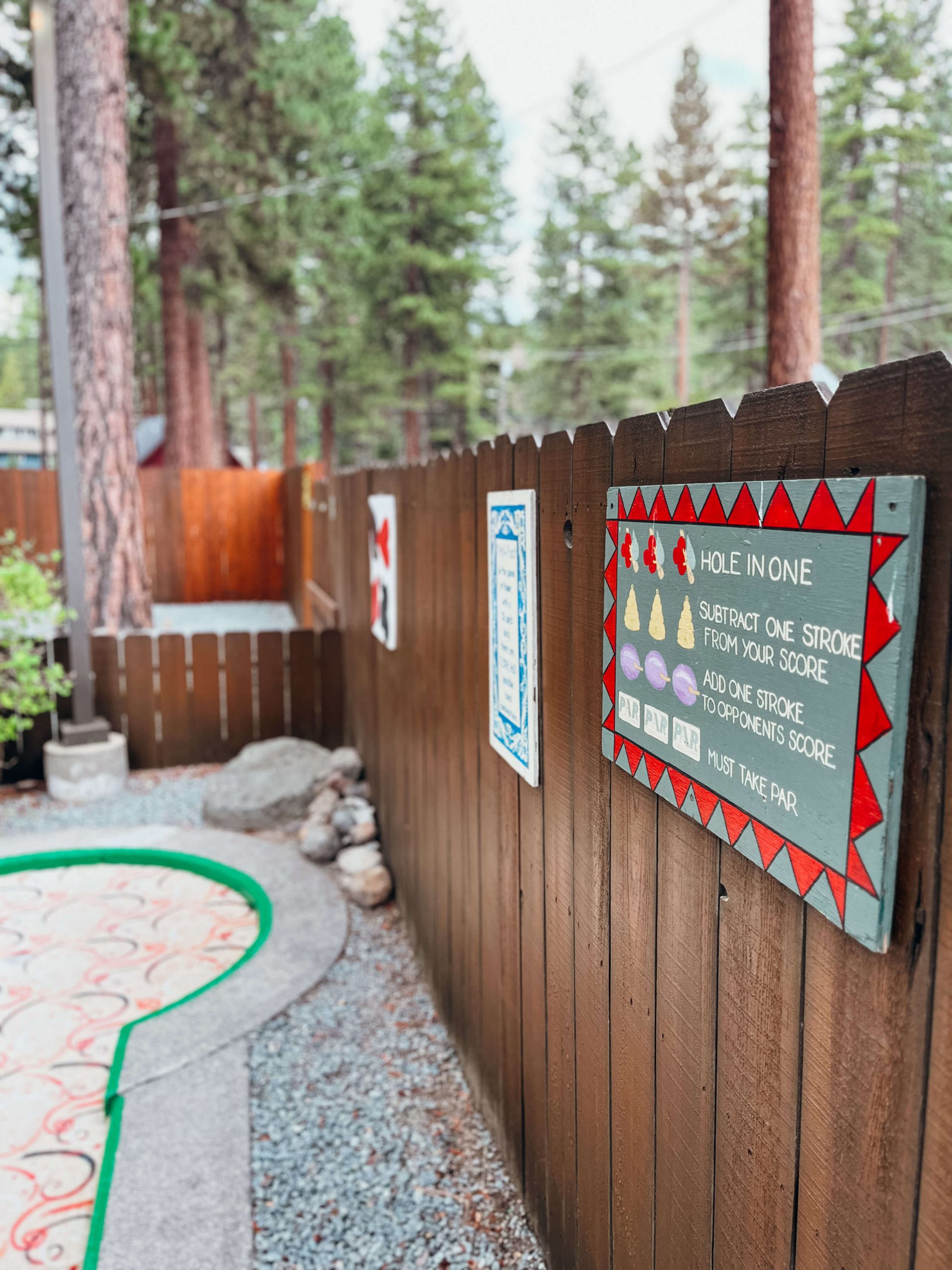 Hand-painted sign on a wooden fence at King's Beach Mini Golf Course near Lake Tahoe