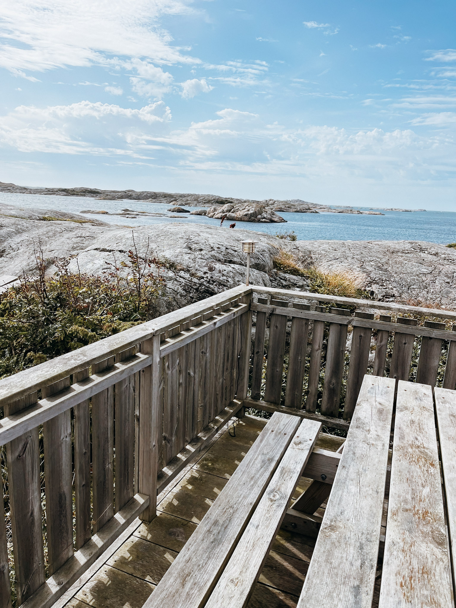 Picnic table on Foto Island Sweden with rocky coastline views