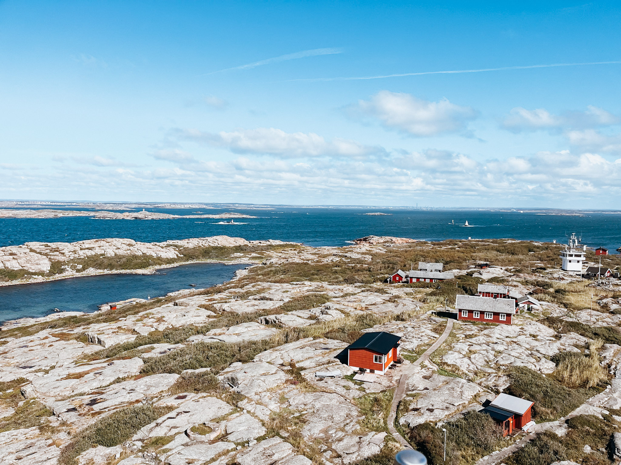 Red and white buildings dot smooth, stone island called Vinga Island in the Gothenburg Archipelago